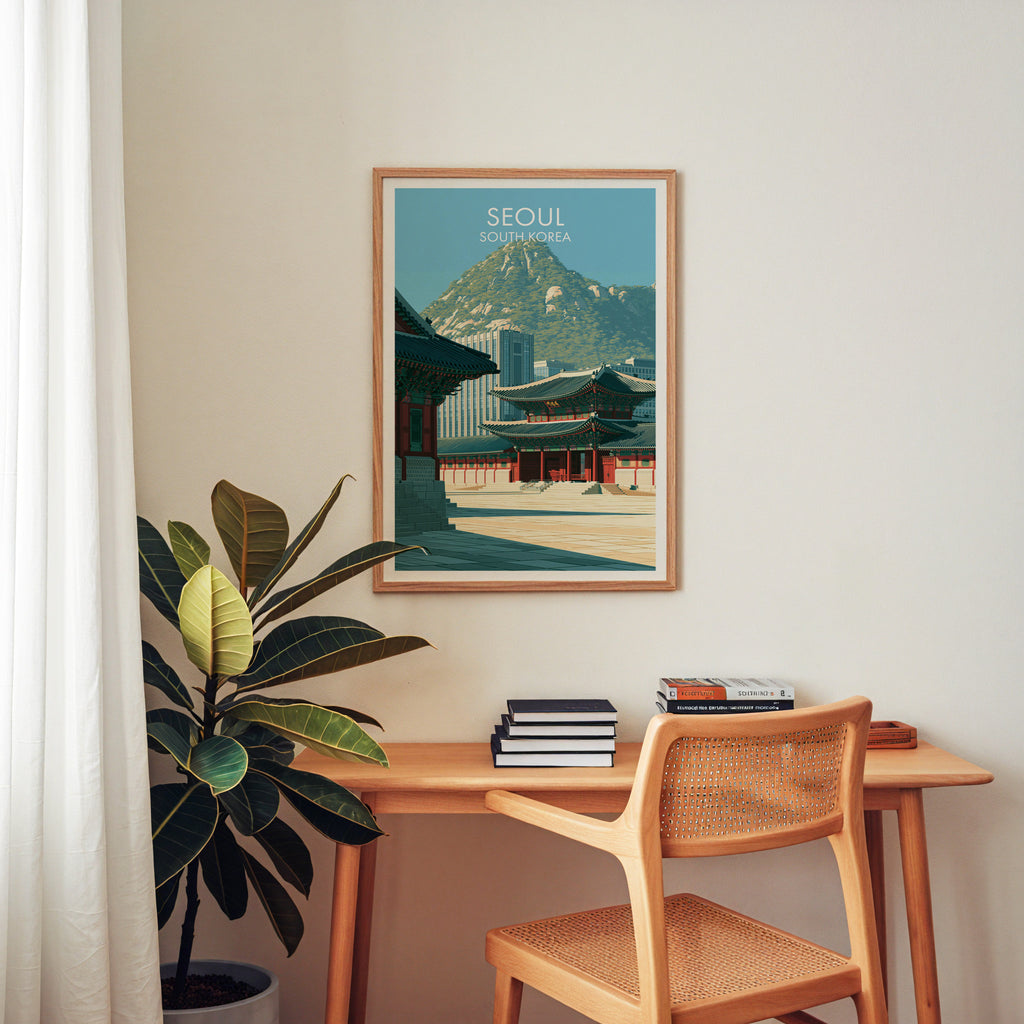 Gyeongbokgung Palace Seoul wall art above a wooden home office desk with a rattan chair and books