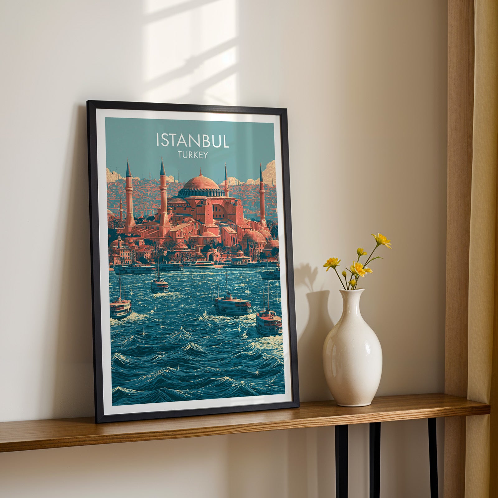 Black framed Hagia Sophia Istanbul Turkey print on a narrow hallway console in sunlight, styled with yellow flowers