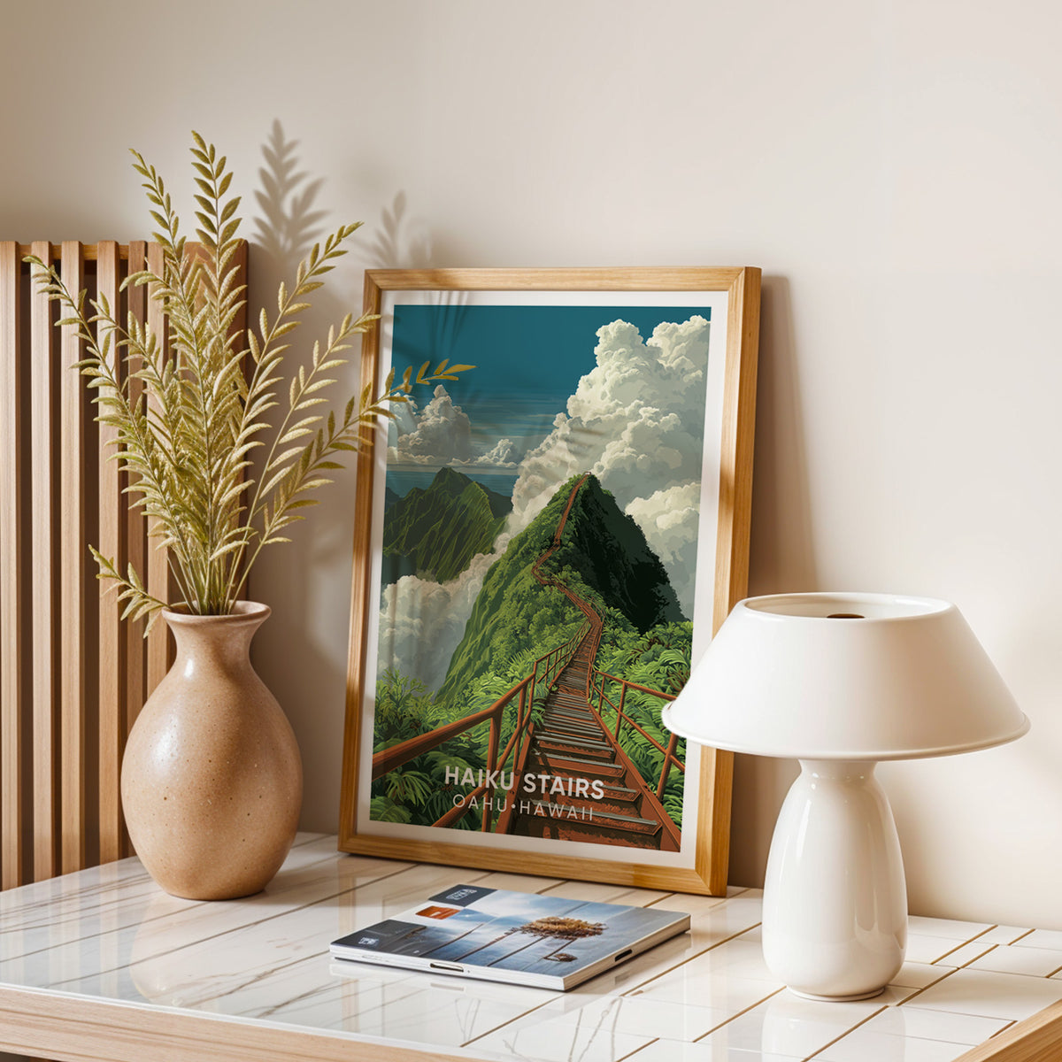 Haiku Stairs wall art on a stone table with a dried-leaf vase, white dome lamp and stacked magazines