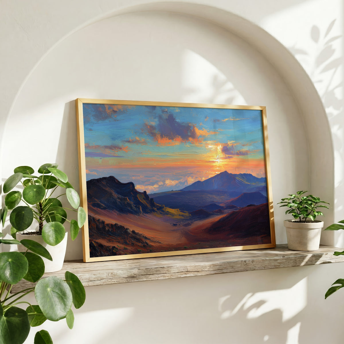 Haleakala oil painting wall art in a gold frame on a wood shelf with potted plants