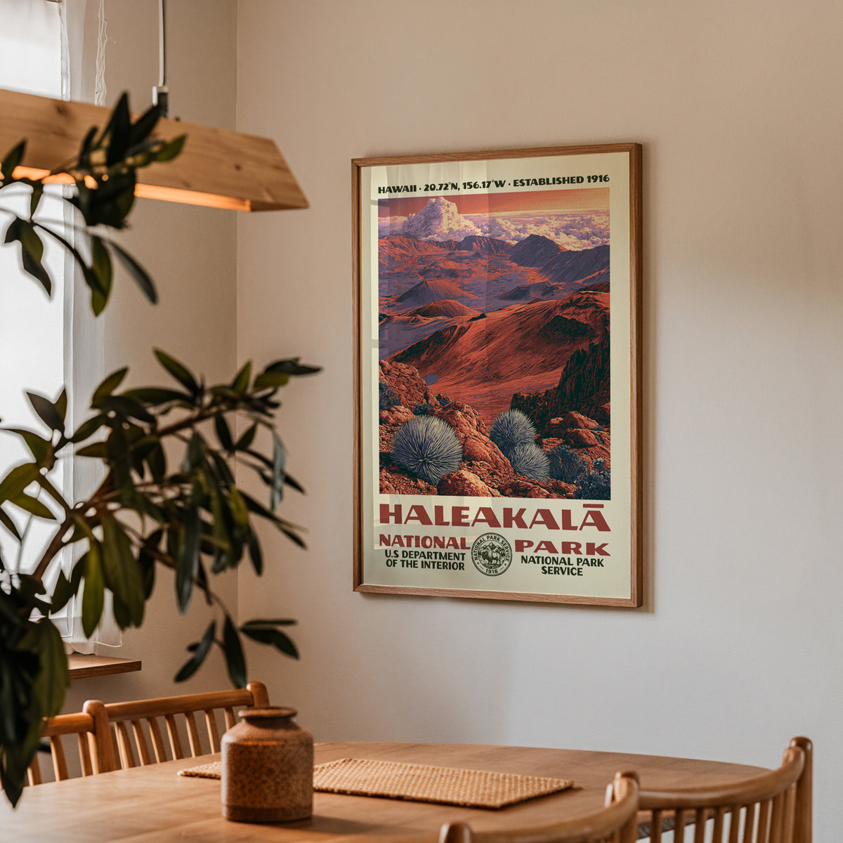 Haleakalā National Park vintage travel print hung above a wooden dining table under a pendant lamp