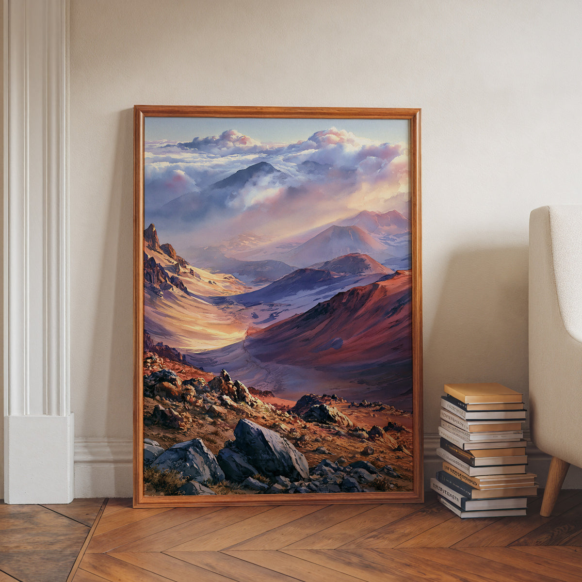Haleakala National Park watercolor print in a walnut frame leaning on a herringbone floor beside stacked books
