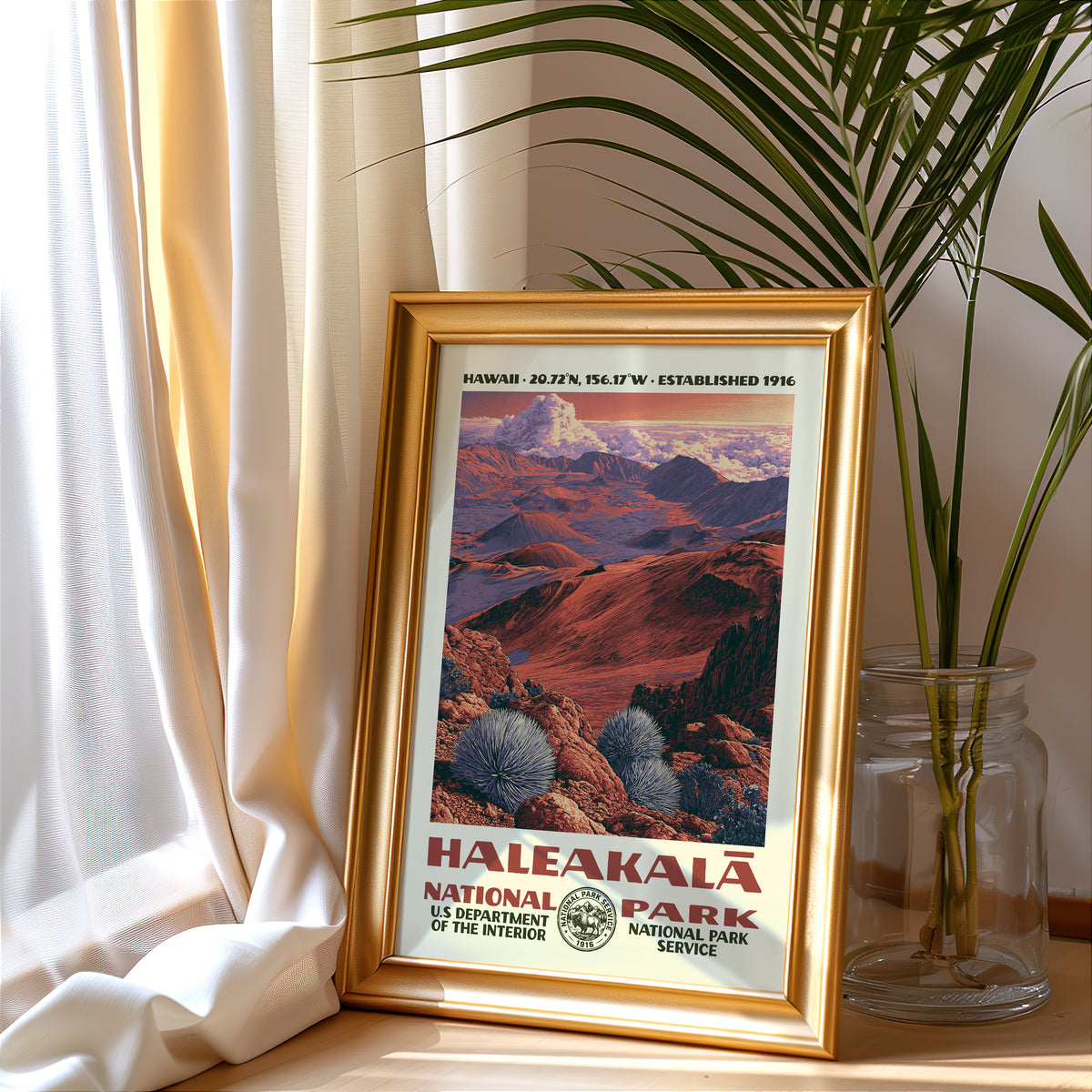 Haleakalā National Park vintage poster in a gold frame beside a linen curtain and potted palm