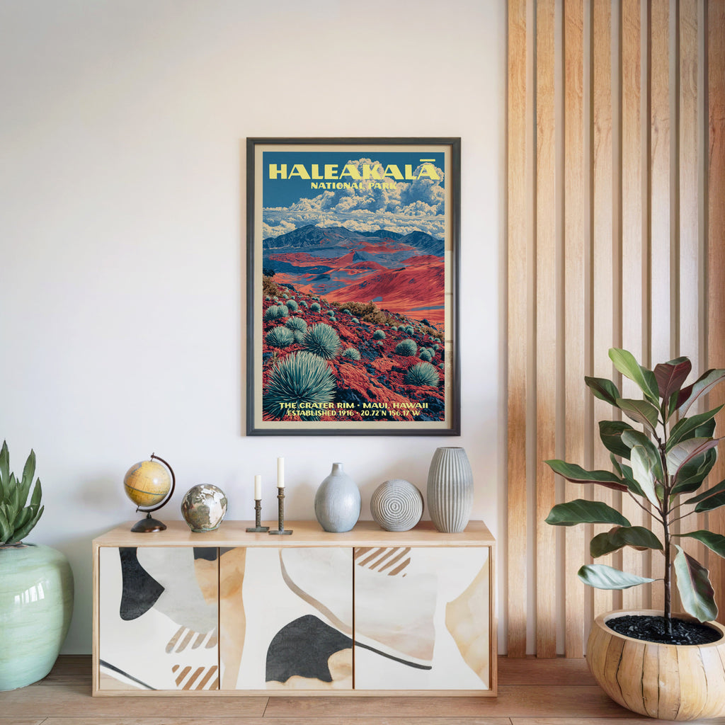 Haleakalā National Park poster in a black frame above a light wood sideboard with a globe and candlesticks