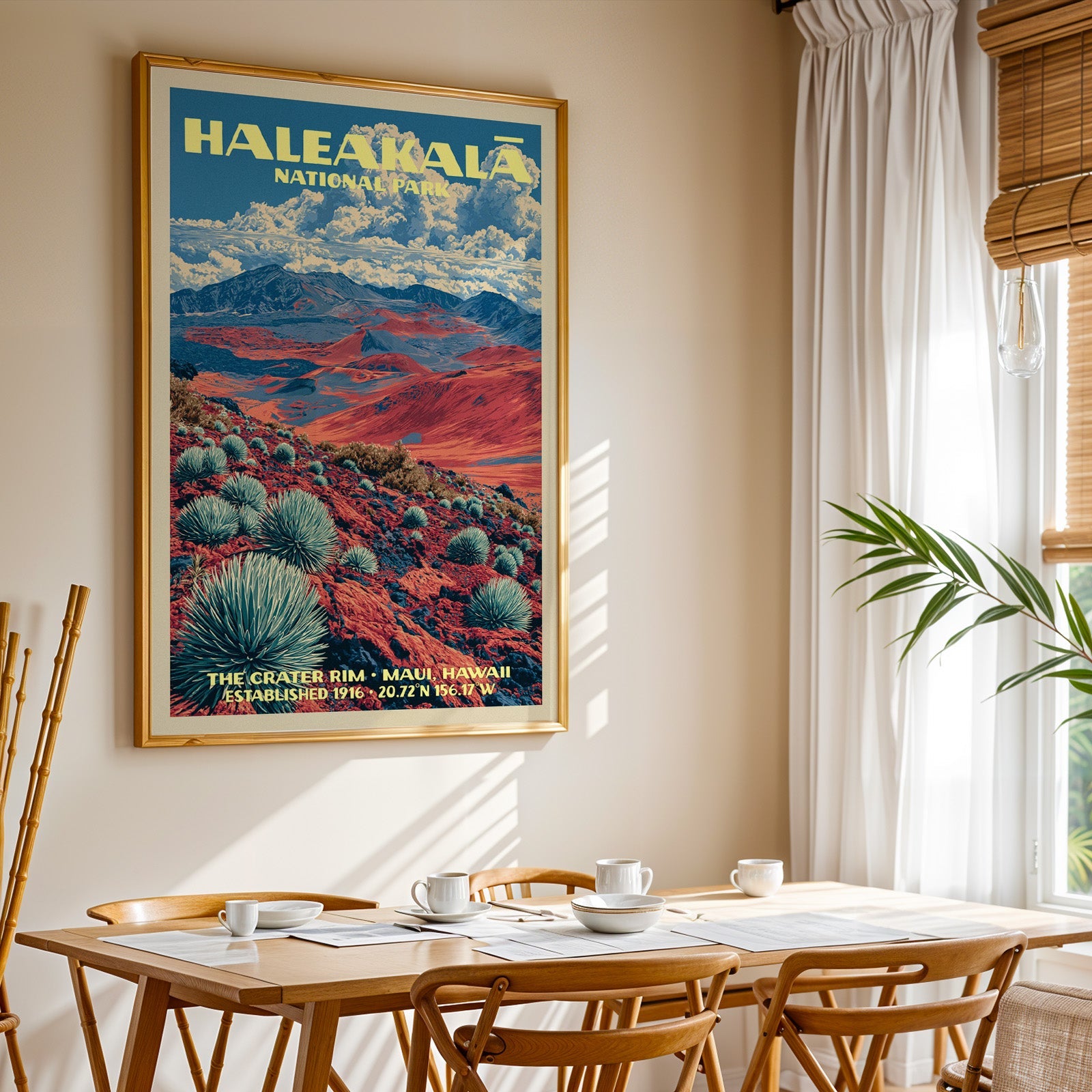 Haleakalā National Park print in a gold frame above a light oak dining table by a curtained window