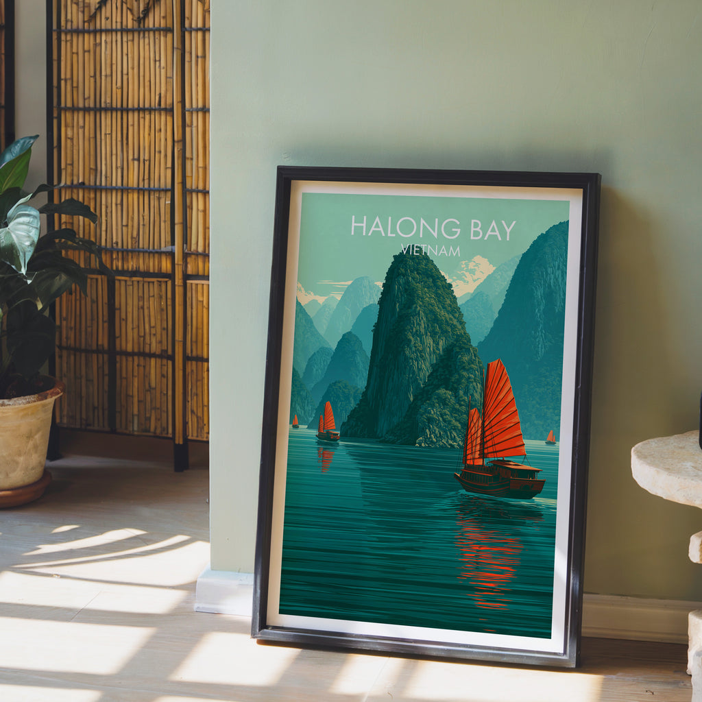 Halong Bay Vietnam wall art in a black frame leaning against a sage green wall beside a bamboo screen