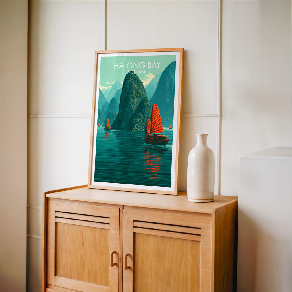 Small Halong Bay Vietnam travel poster in an oak frame on a mid-century sideboard with a ceramic vase