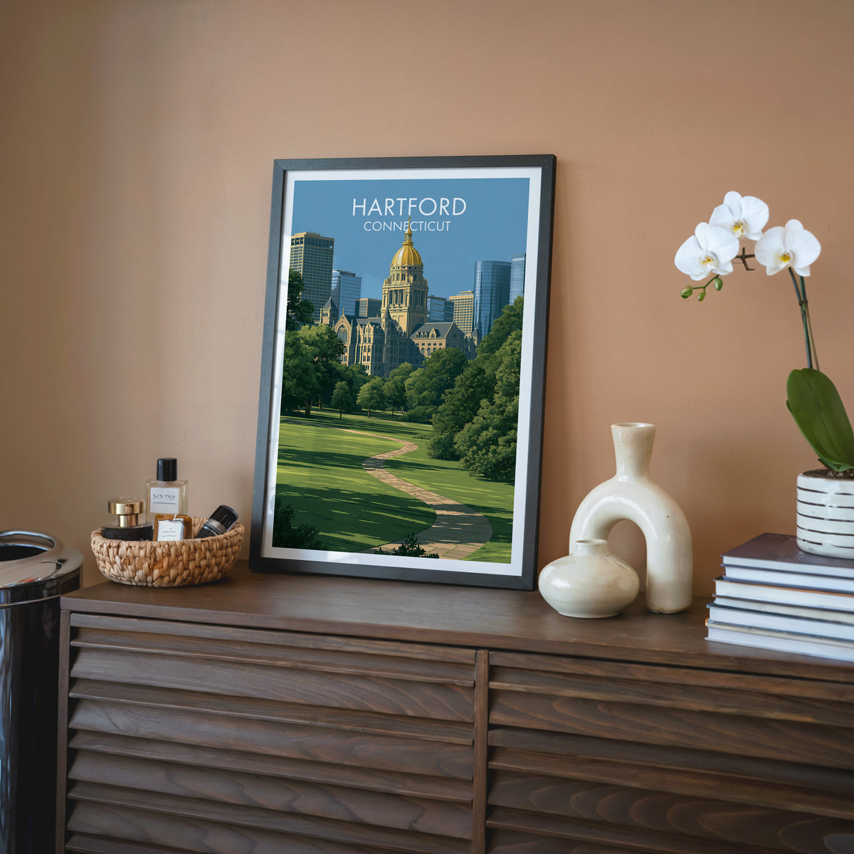 Gold-domed capitol wall art in a black frame on a walnut sideboard by a terracotta wall