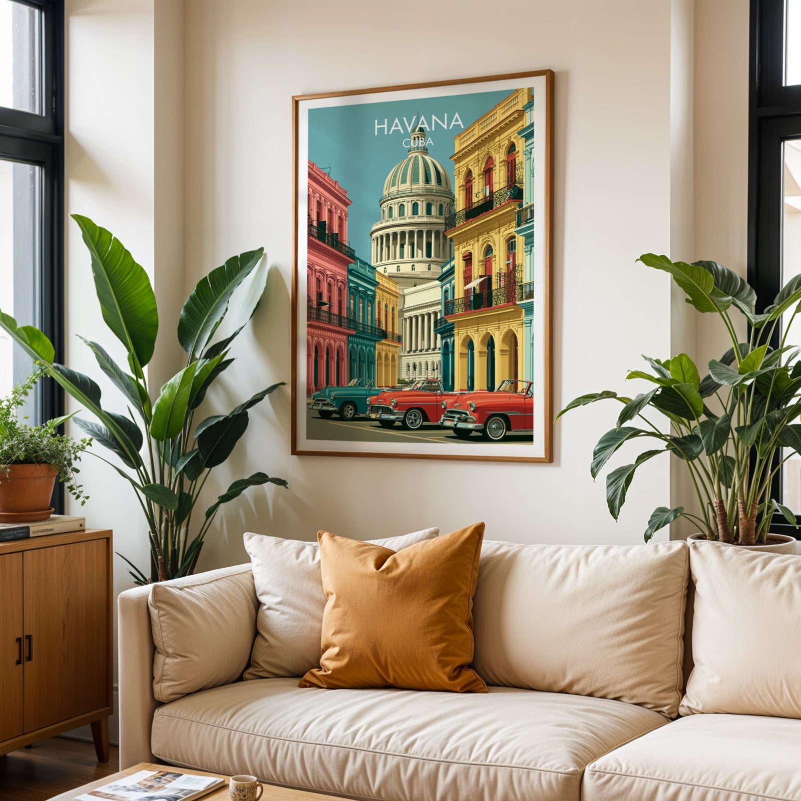 Havana Cuba poster in an oak frame above a cream sofa with a burnt-orange cushion and two tall tropical plants
