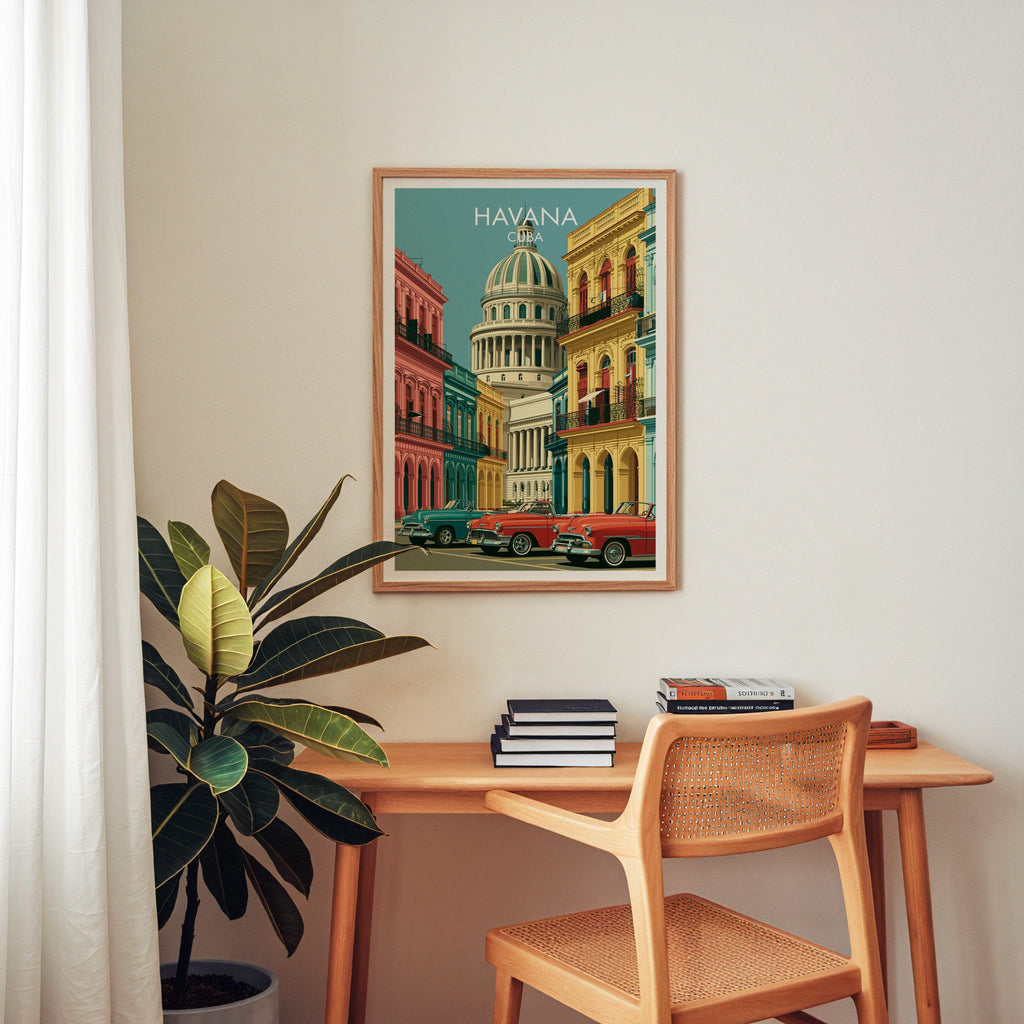 Vintage-style Havana poster in an oak frame above a wooden home-office desk with a cane chair and rubber plant