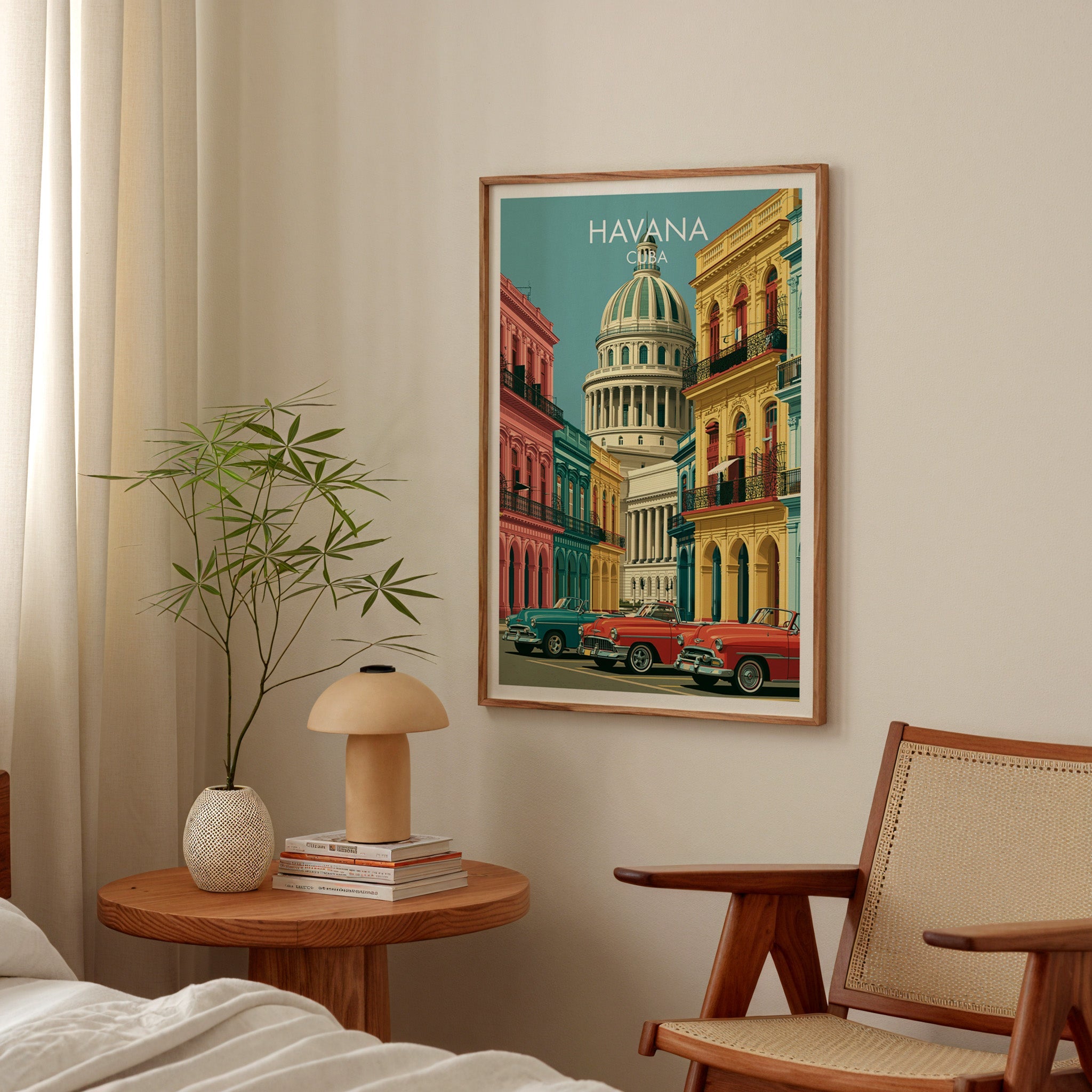 Teal and coral Havana print in an oak frame in a bedroom above a round table with a mushroom lamp and bamboo