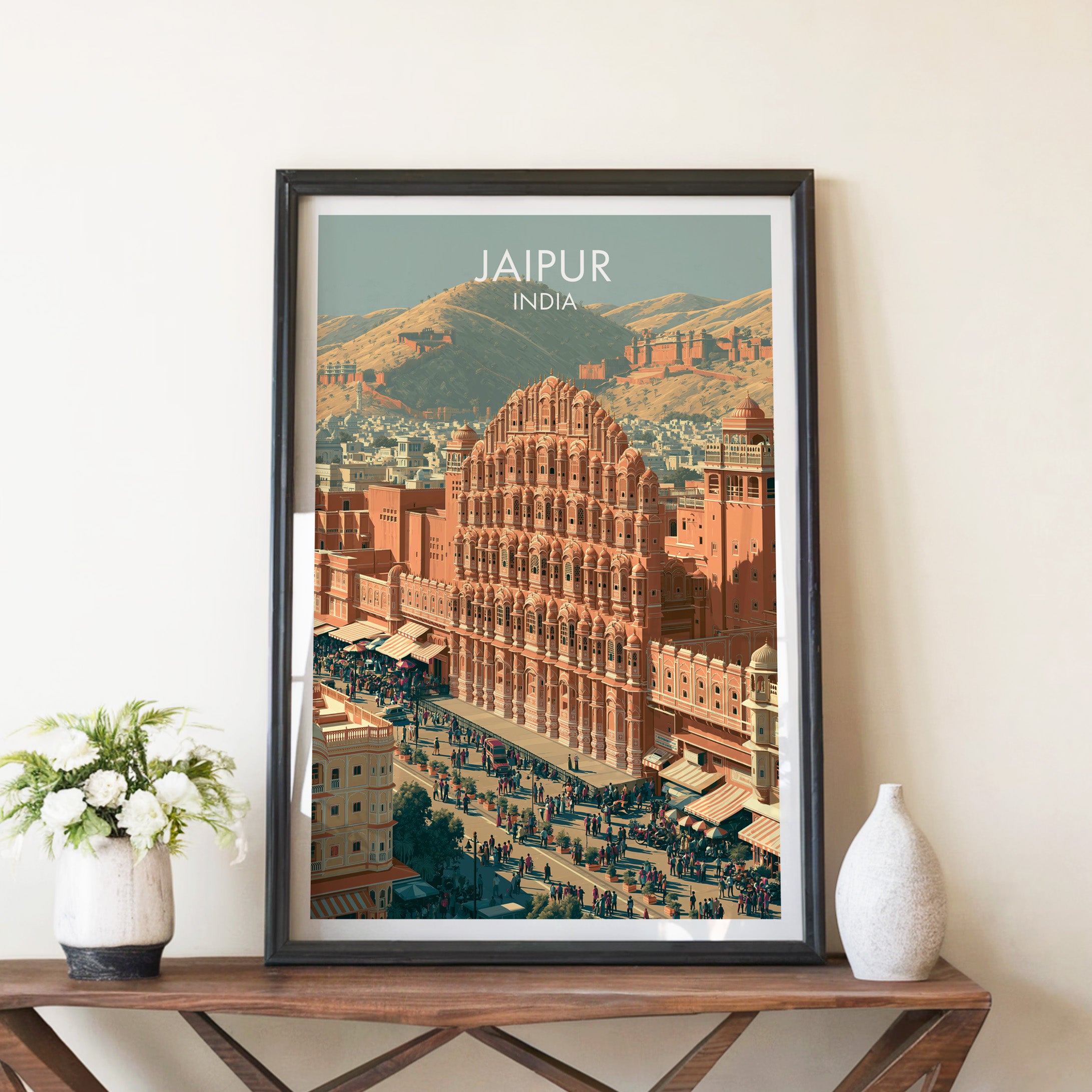 Hawa Mahal Jaipur India travel poster in a black frame on a wooden console table with white flowers