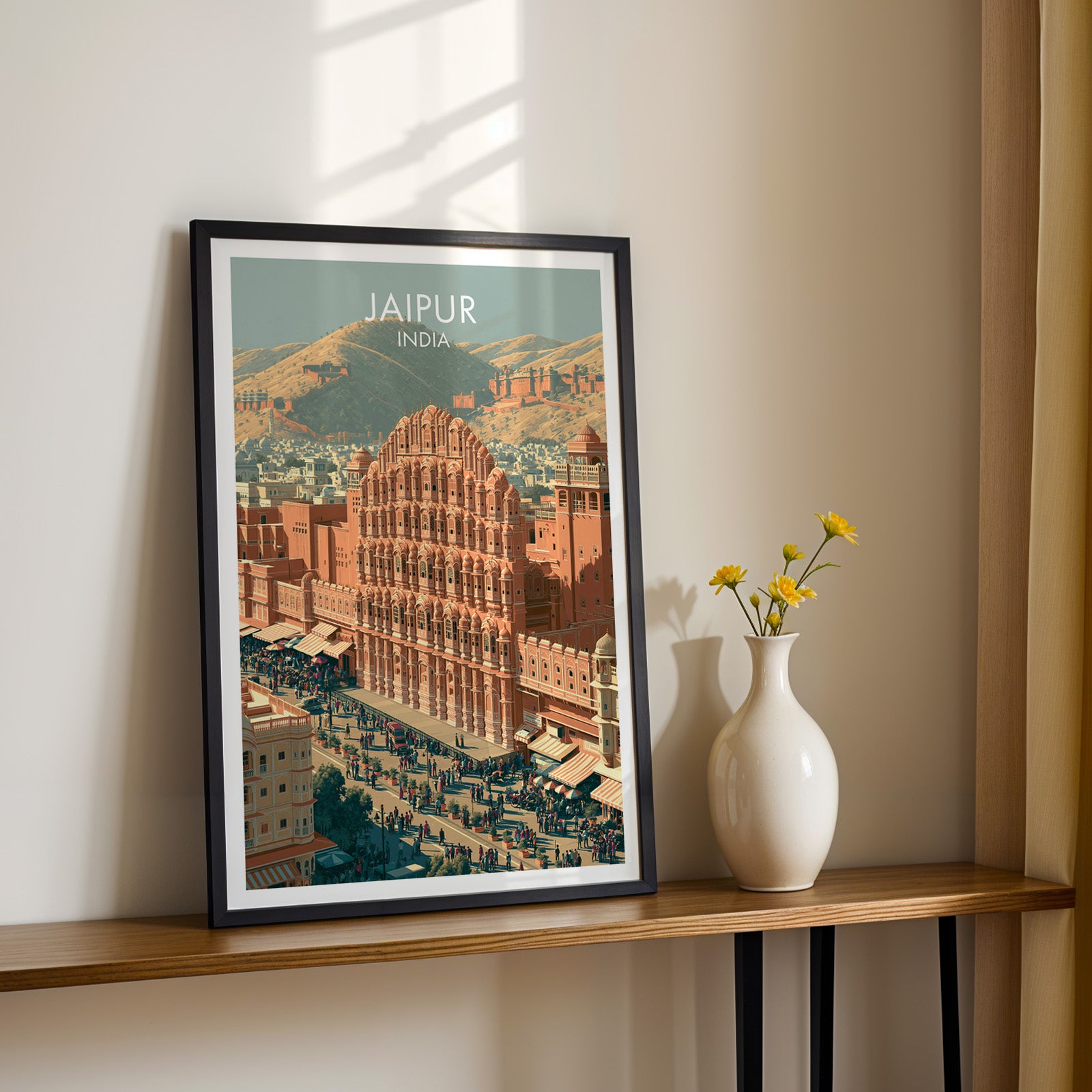 Black framed Hawa Mahal Jaipur India print on a narrow hallway console in sunlight, styled with yellow flowers
