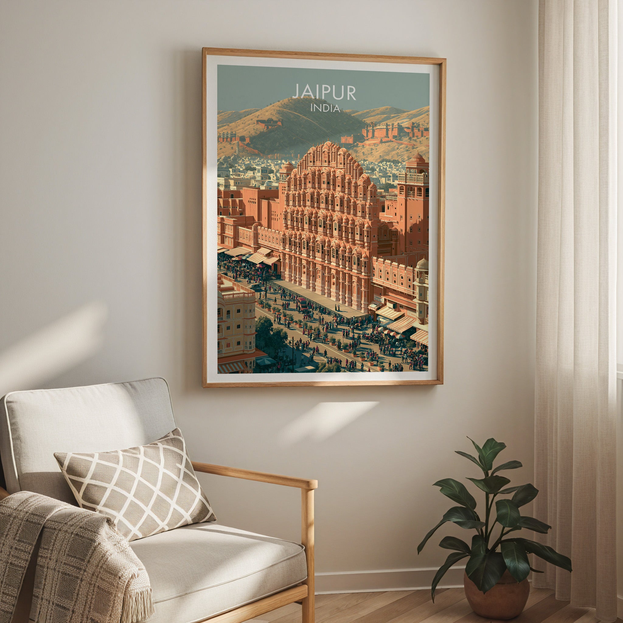 Hawa Mahal Jaipur India travel print in a light oak frame on a living room wall beside a linen armchair