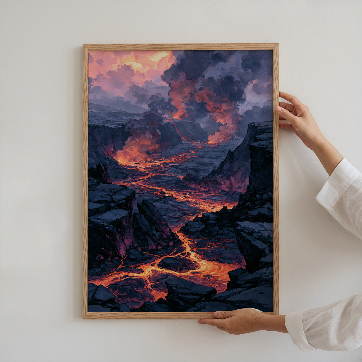 Hands holding an oak-framed Hawaii Volcanoes National Park watercolor art print against a plain white wall