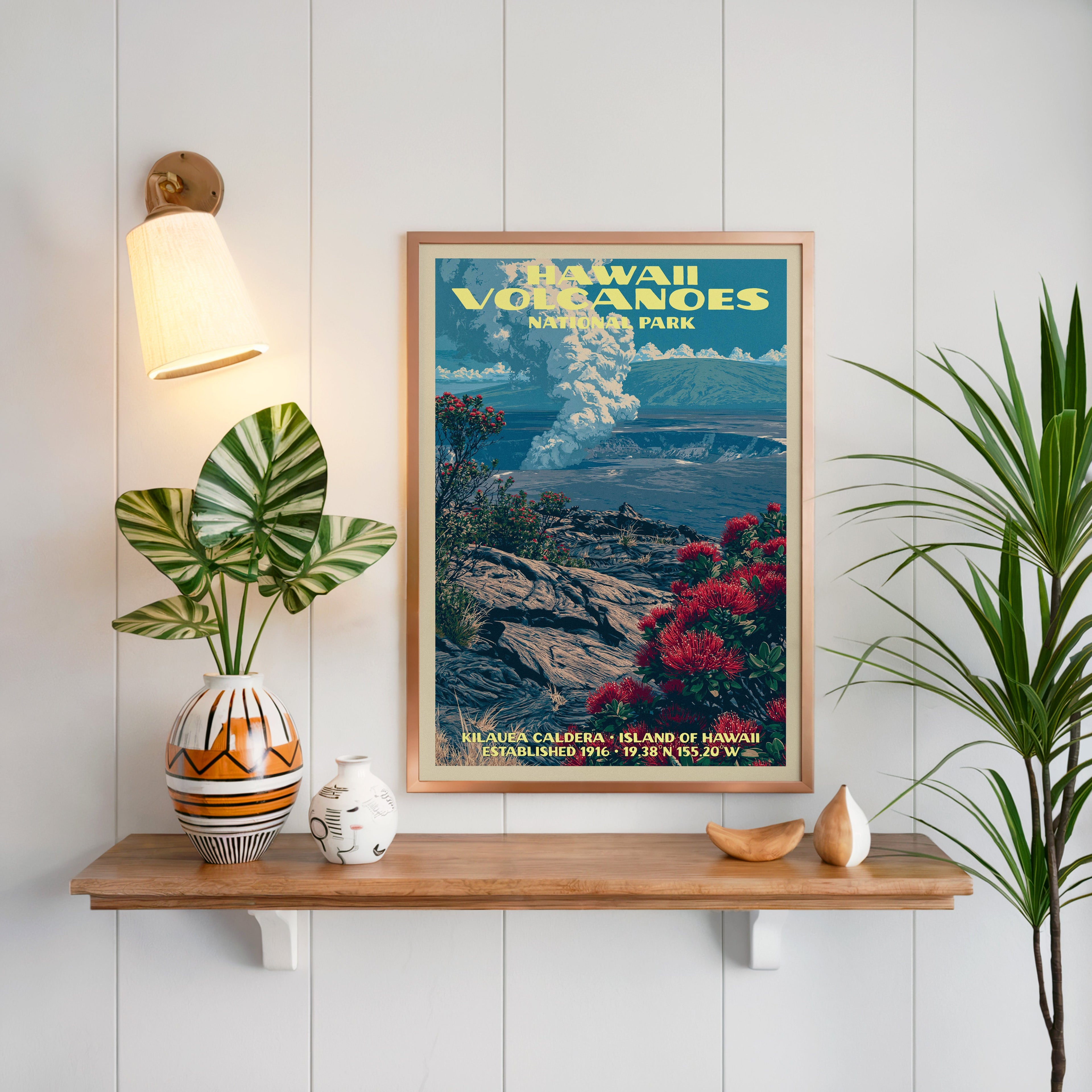 Hawaii Volcanoes print framed on white panelling above a floating oak shelf with a patterned vase and sconce