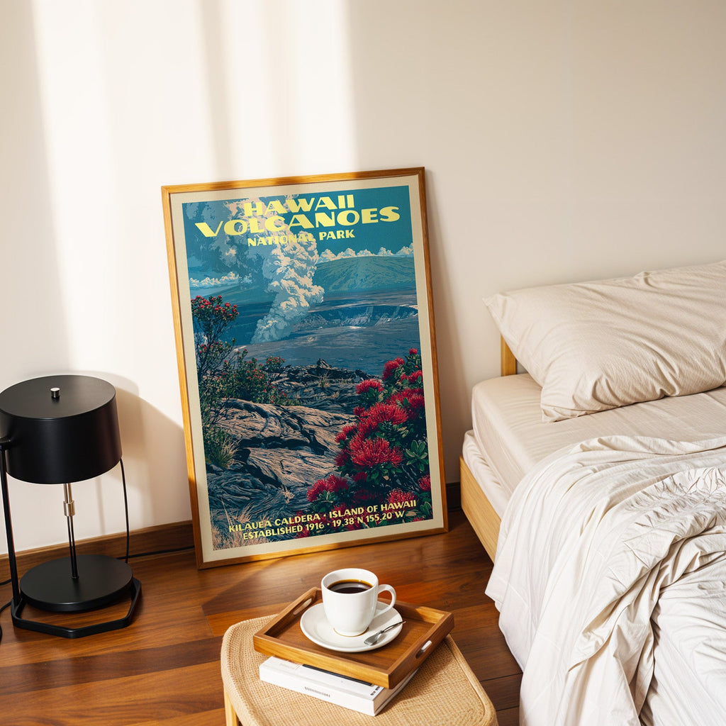 Kilauea lehua poster in a gold frame on the bedroom floor beside a made bed and a black table lamp