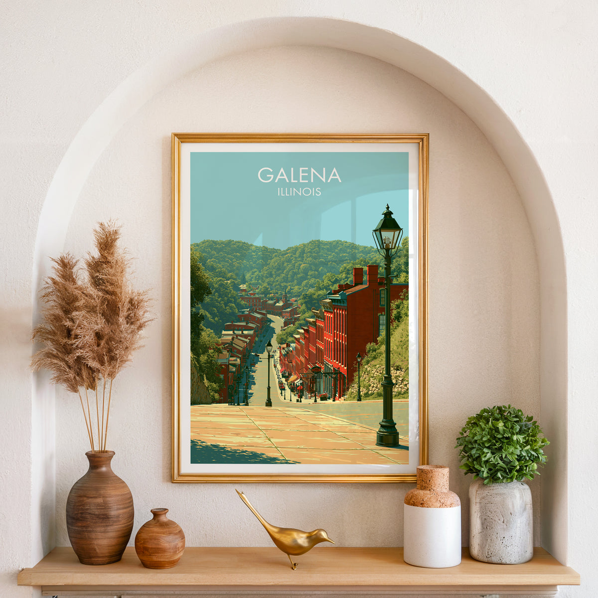 Historic Midwest street artwork in a gold frame set in an arched wall niche with pampas grass and brass bird