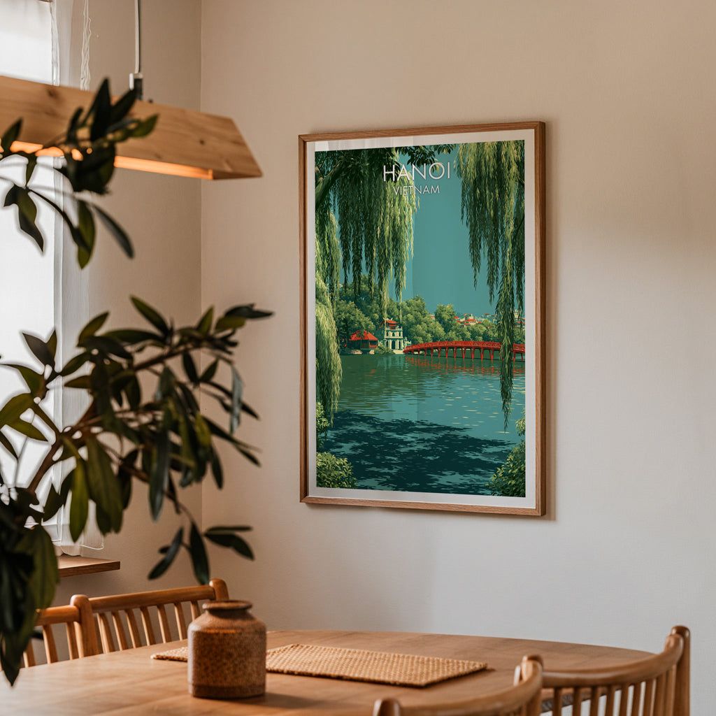 Framed Hoan Kiem Lake Hanoi Vietnam print on a dining room wall above an oak table in warm afternoon light