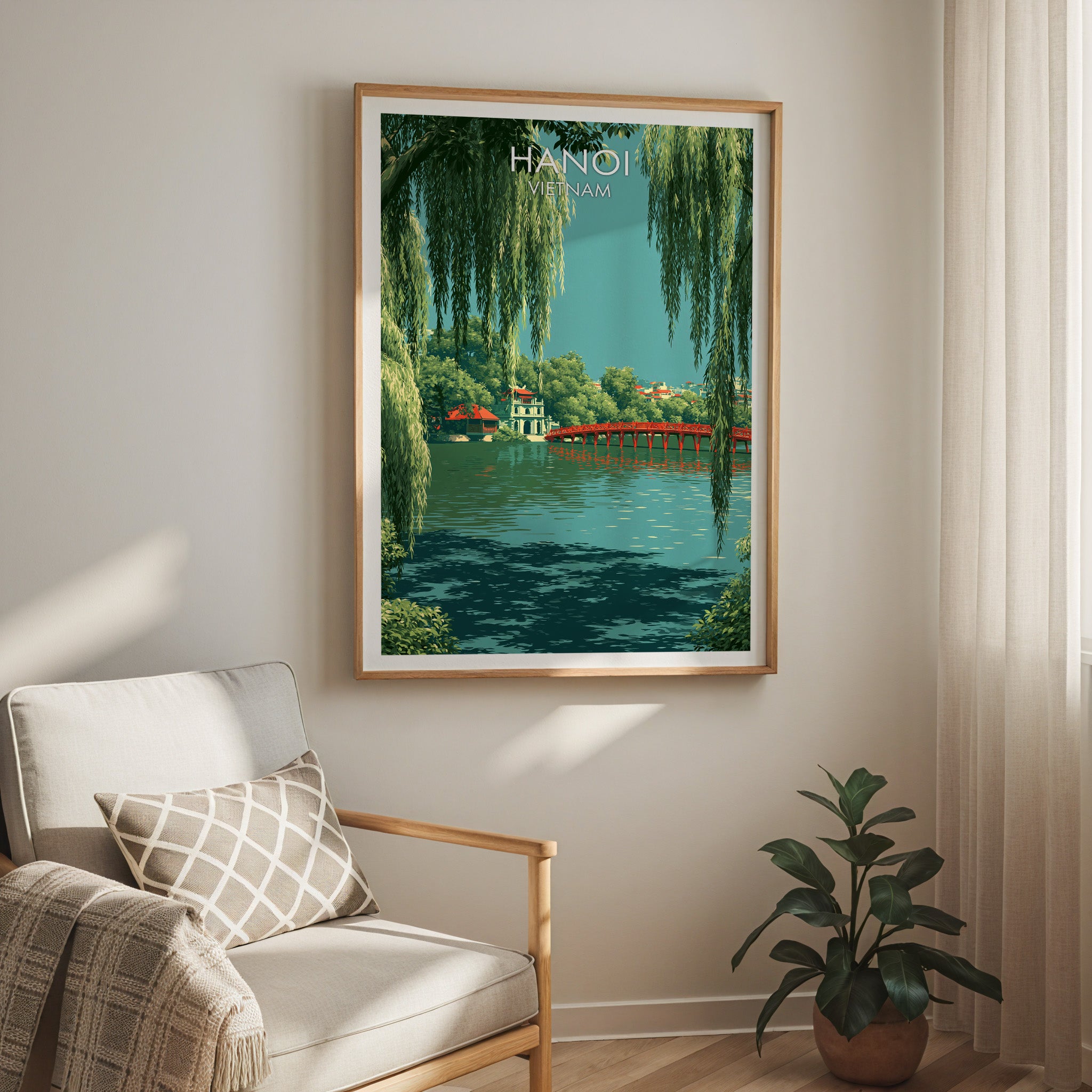 Hoan Kiem Lake Hanoi Vietnam travel print in a light oak frame on a living room wall beside a linen armchair