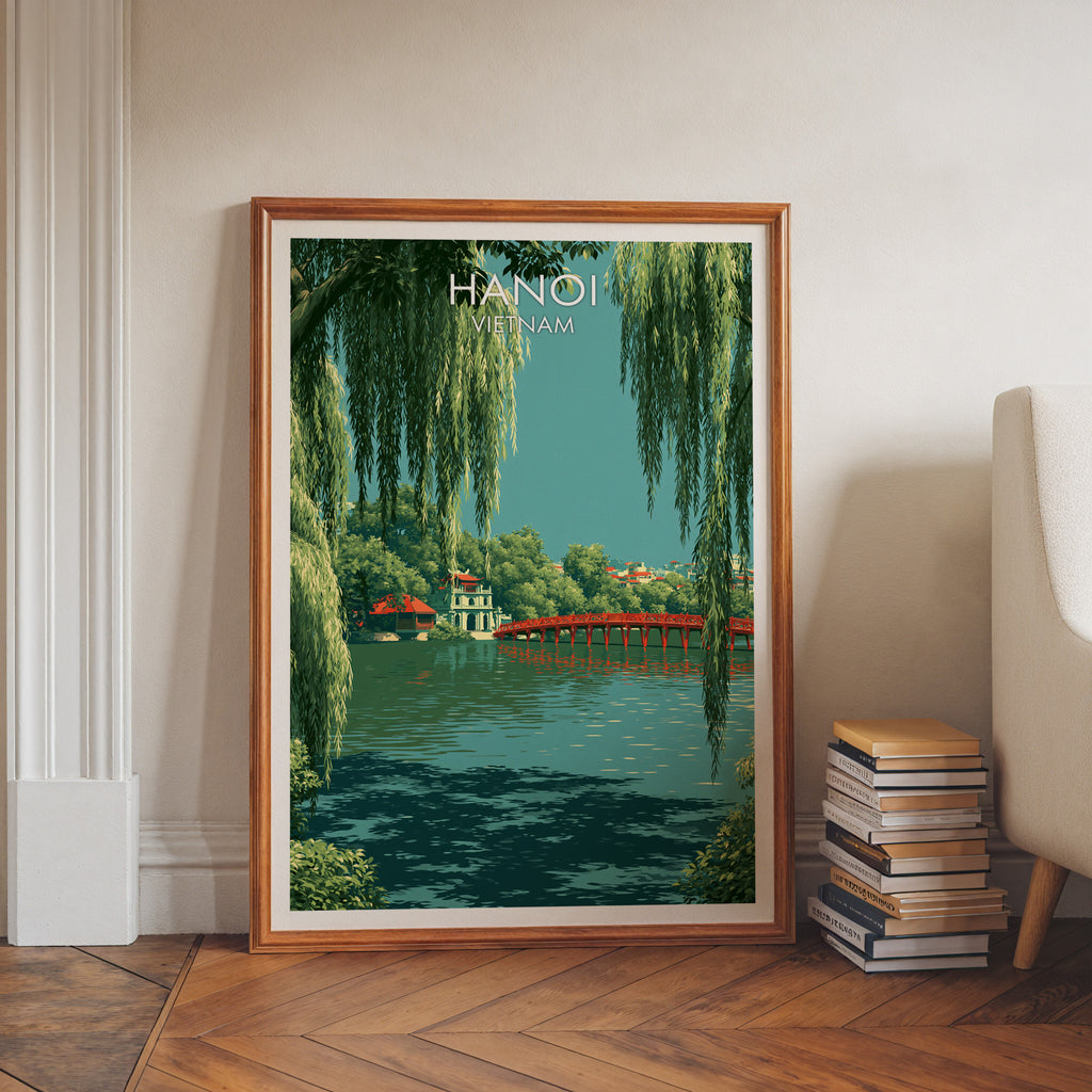 Hoan Kiem Lake Hanoi Vietnam art print in a walnut frame leaning in a hallway beside stacked books