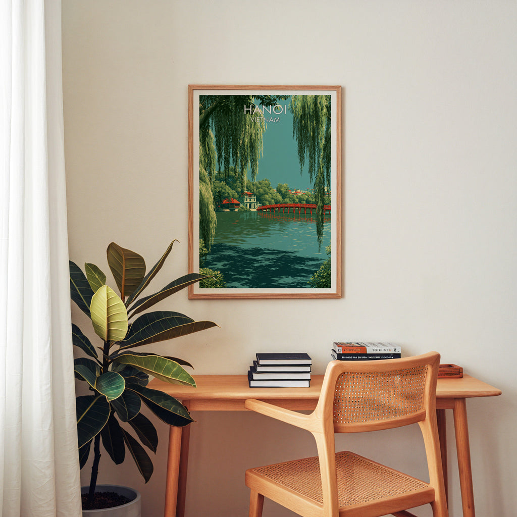 Hoan Kiem Lake Hanoi Vietnam wall art above a wooden home office desk with a rattan chair and books