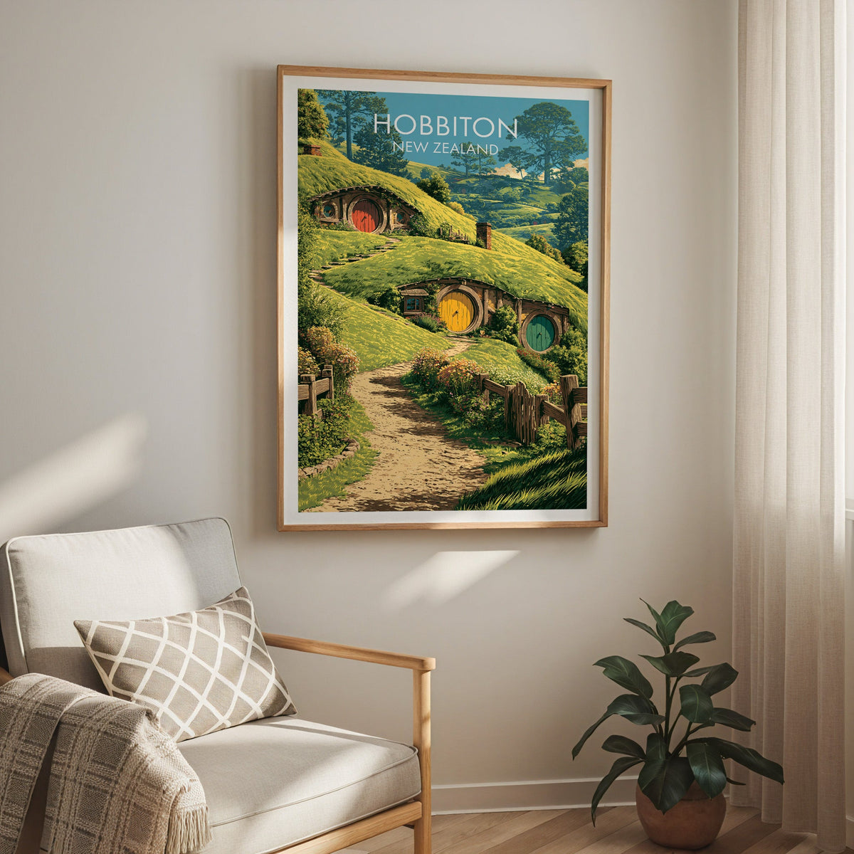 Matamata print above a cream armchair with a sheer curtain and a rubber plant in a terracotta pot