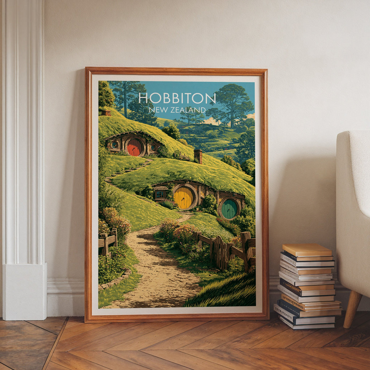 Rolling green farm hills artwork in a walnut frame on a herringbone floor beside stacked books