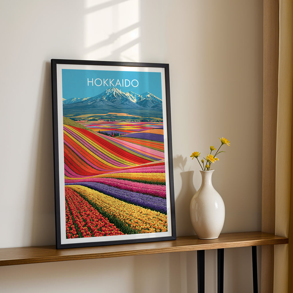 Black framed Hokkaido Japan print on a narrow hallway console in sunlight, styled with yellow flowers