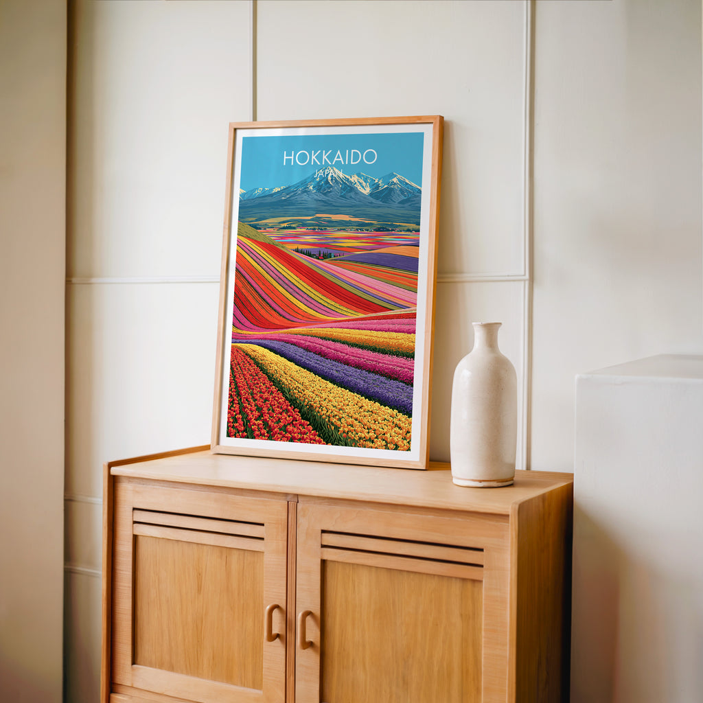 Small Hokkaido Japan travel poster in an oak frame on a mid-century sideboard with a ceramic vase