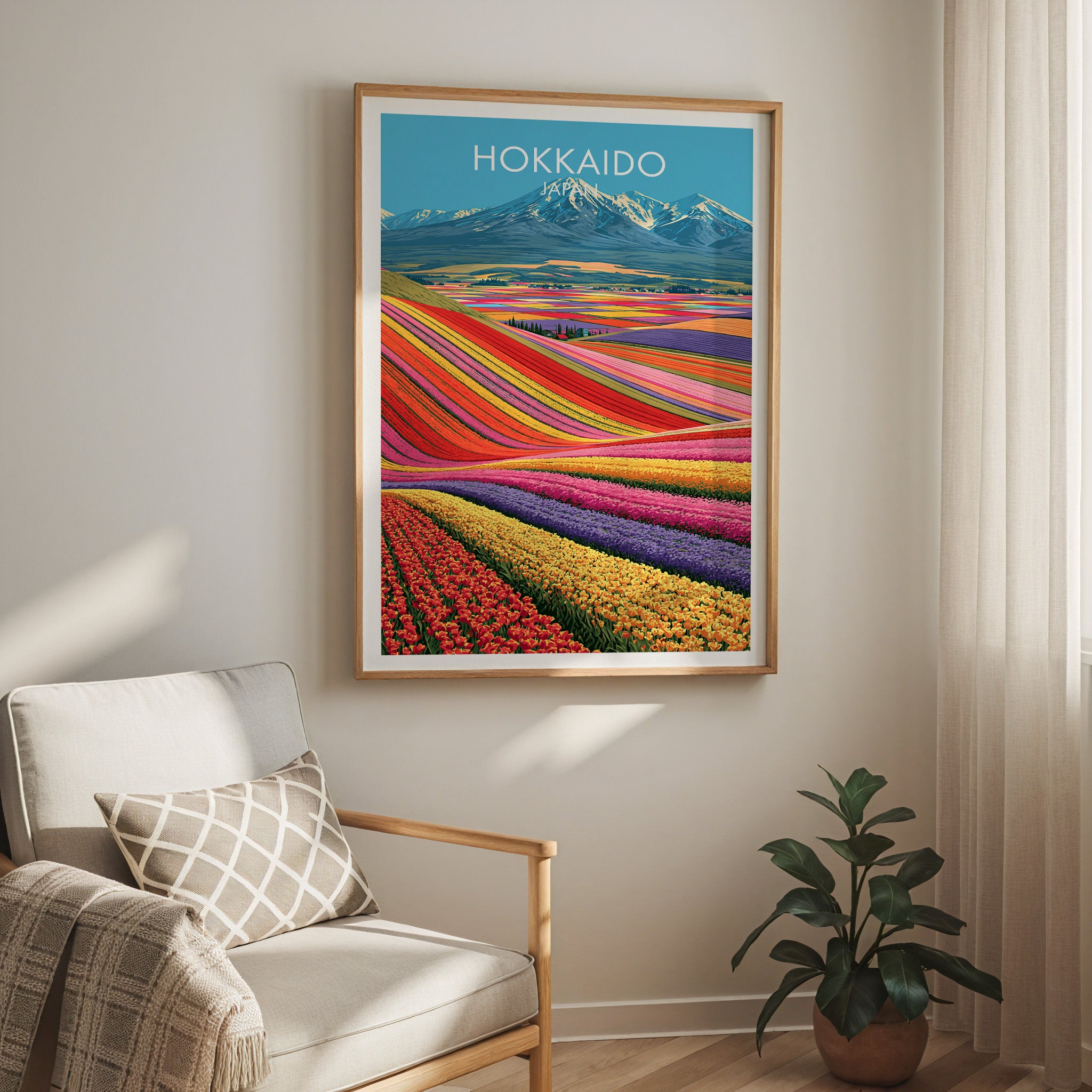 Hokkaido Japan travel print in a light oak frame on a living room wall beside a linen armchair