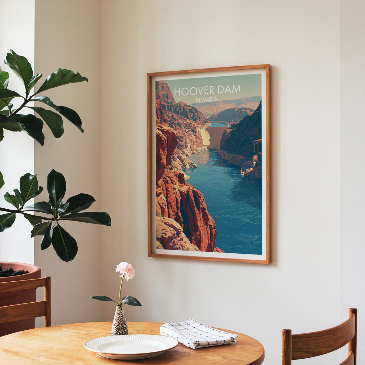Canyon river print in a walnut frame in a dining corner with a round table and a fiddle-leaf fig.