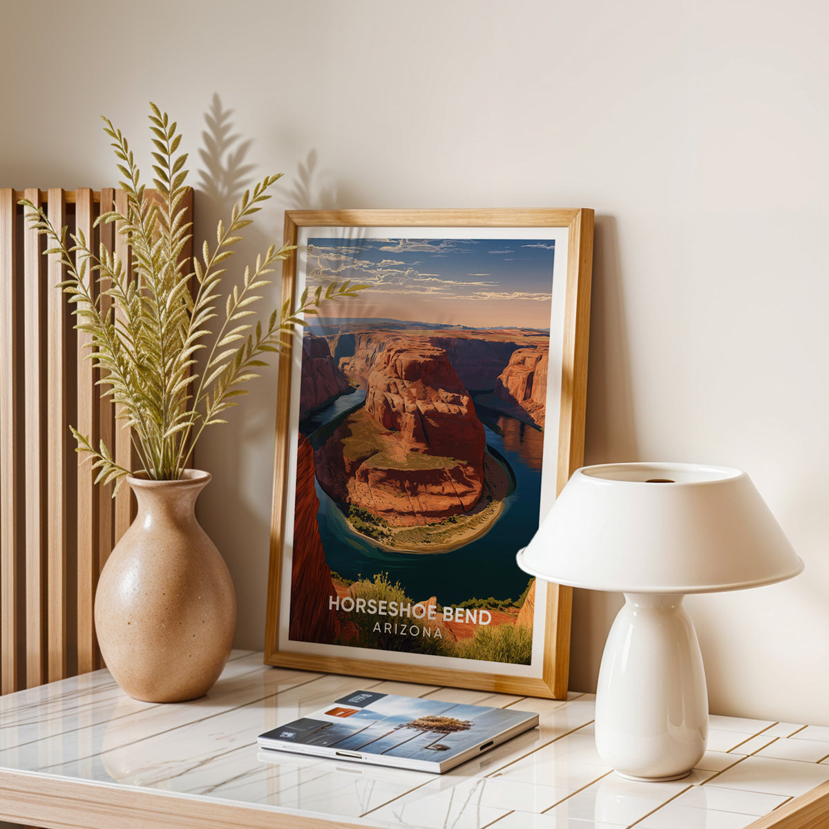 Horseshoe Bend art print on a stone table with a dome lamp, magazines and dried leaves in a jar