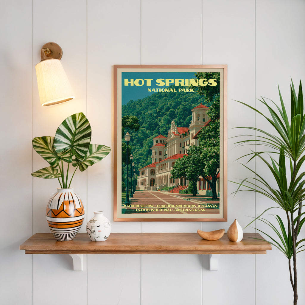 Hot Springs print framed on white panelling above a floating oak shelf with a patterned vase and brass sconce