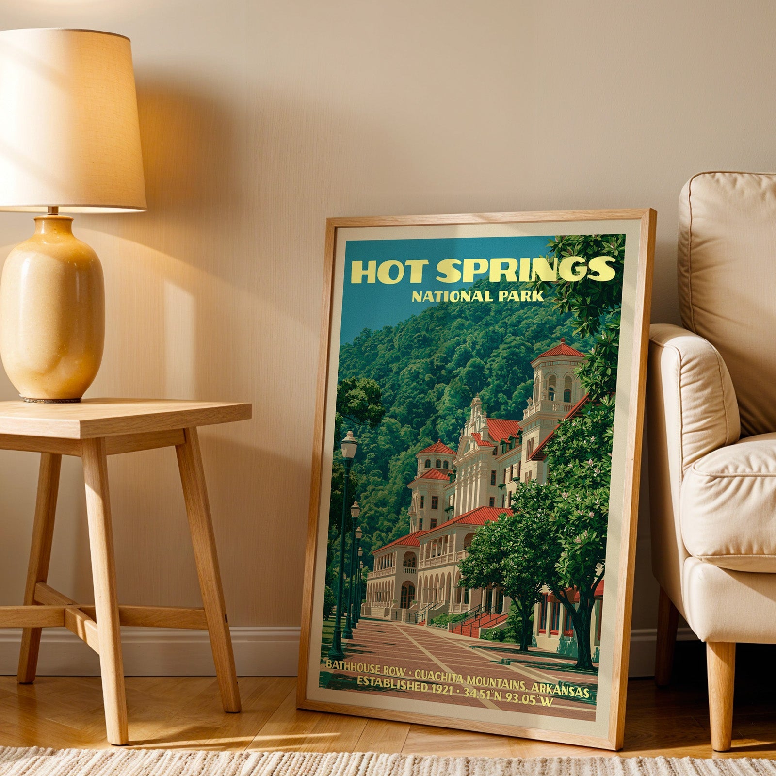 Arkansas bathhouse wall art in oak, leaning by a cream armchair and a side table with an ochre ceramic lamp