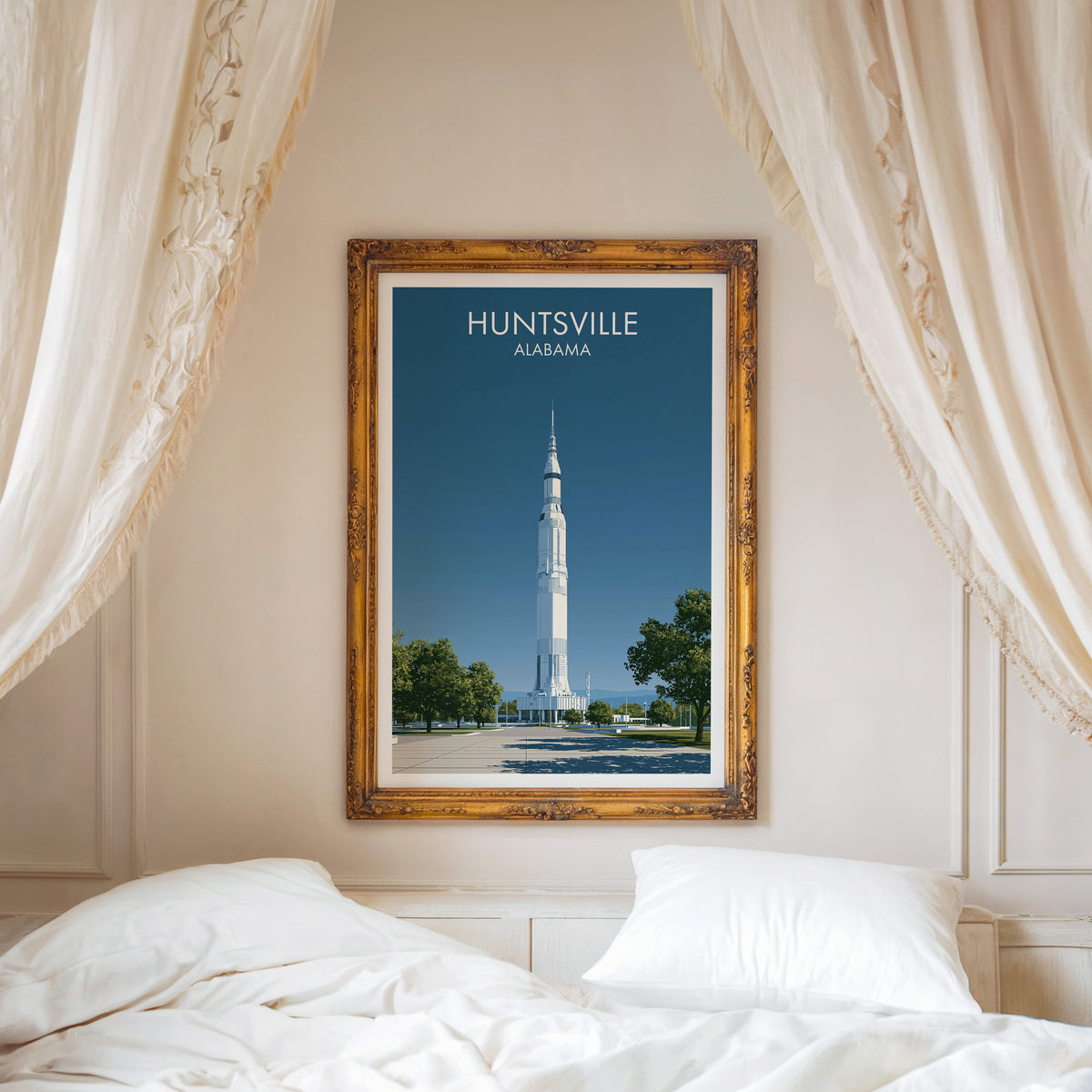 Huntsville canvas print in a carved gold frame above a white headboard with linen canopy drapes