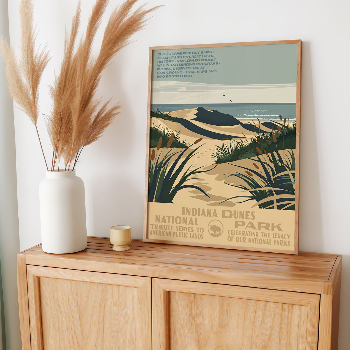 Indiana Dunes National Park wall art leaning on an oak sideboard with pampas grass in a vase