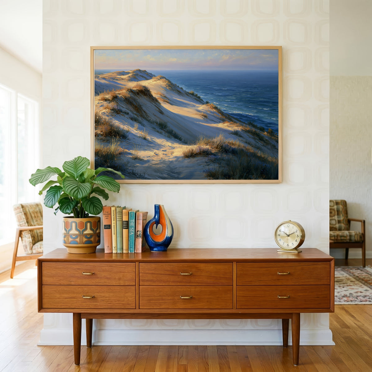 Indiana Dunes art print above a mid-century teak credenza with retro wallpaper