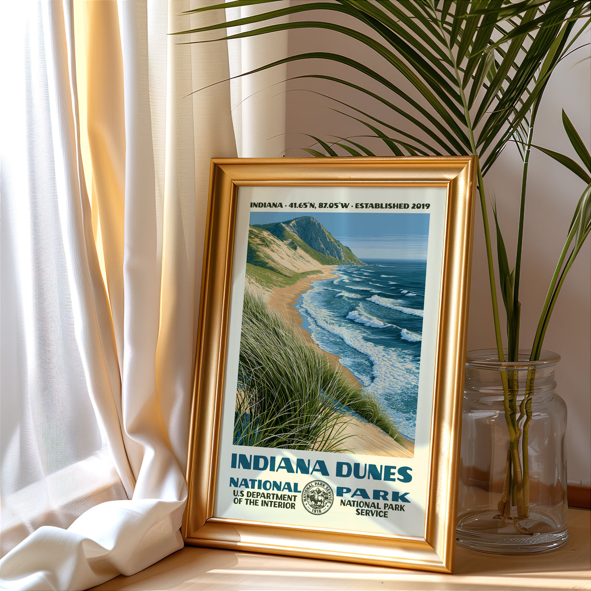 Indiana Dunes National Park vintage poster in a gold frame beside a linen curtain and potted palm