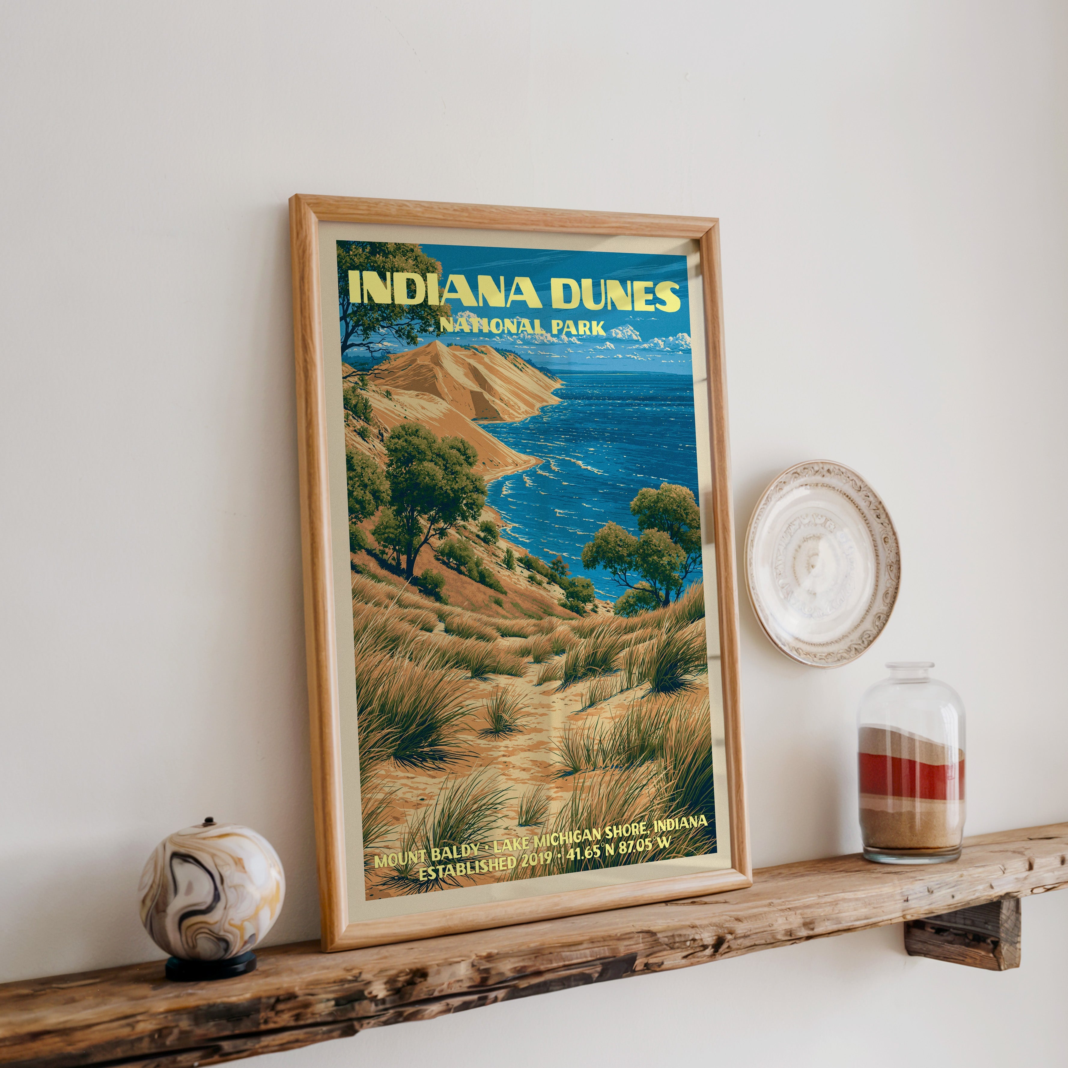 Indiana Dunes print in oak, leaning on a reclaimed wood ledge with a marbled stone sphere and a sand jar