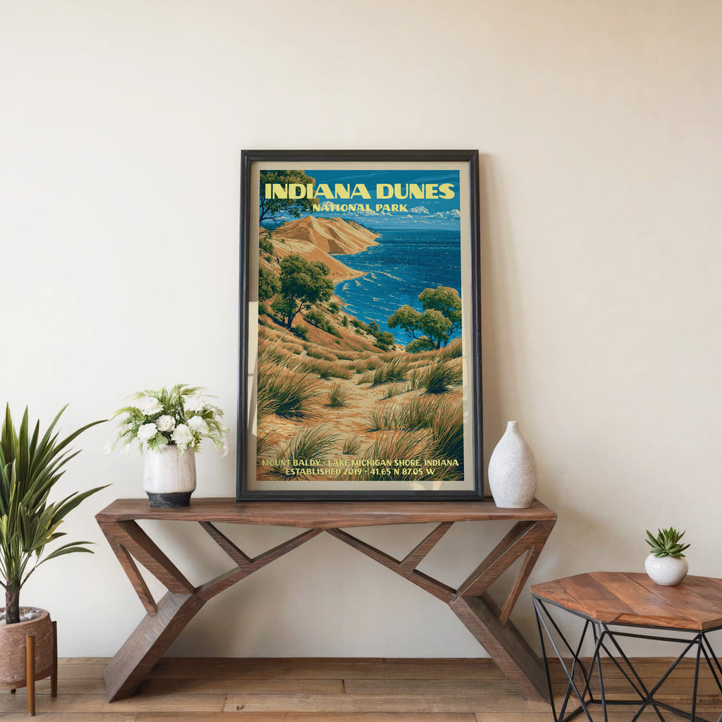 Mount Baldy wall art in a black frame, leaning on a walnut console with white anemones in a stoneware vase