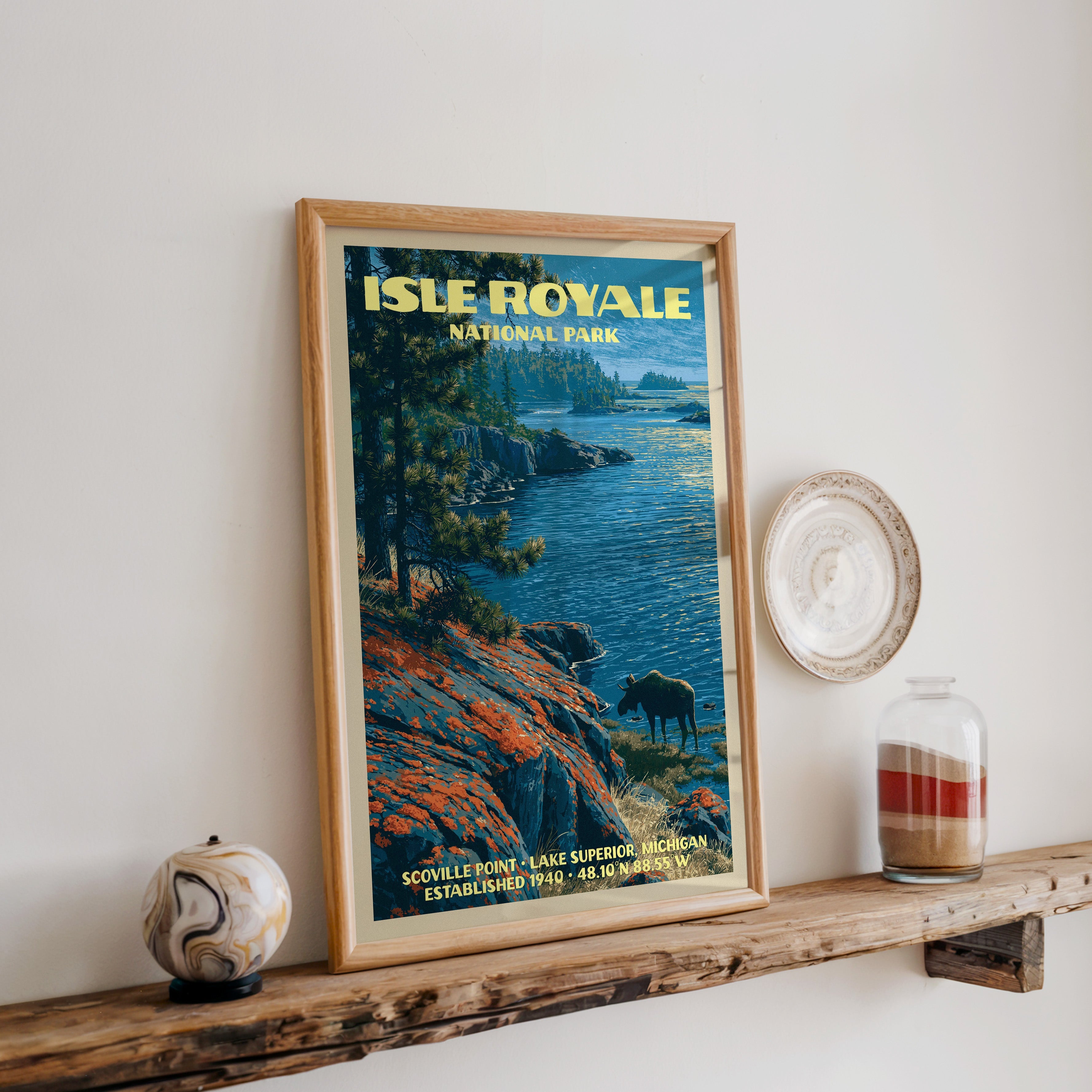 Isle Royale Scoville Point print in oak, leaning on a reclaimed wood ledge with a marbled sphere and sand jar