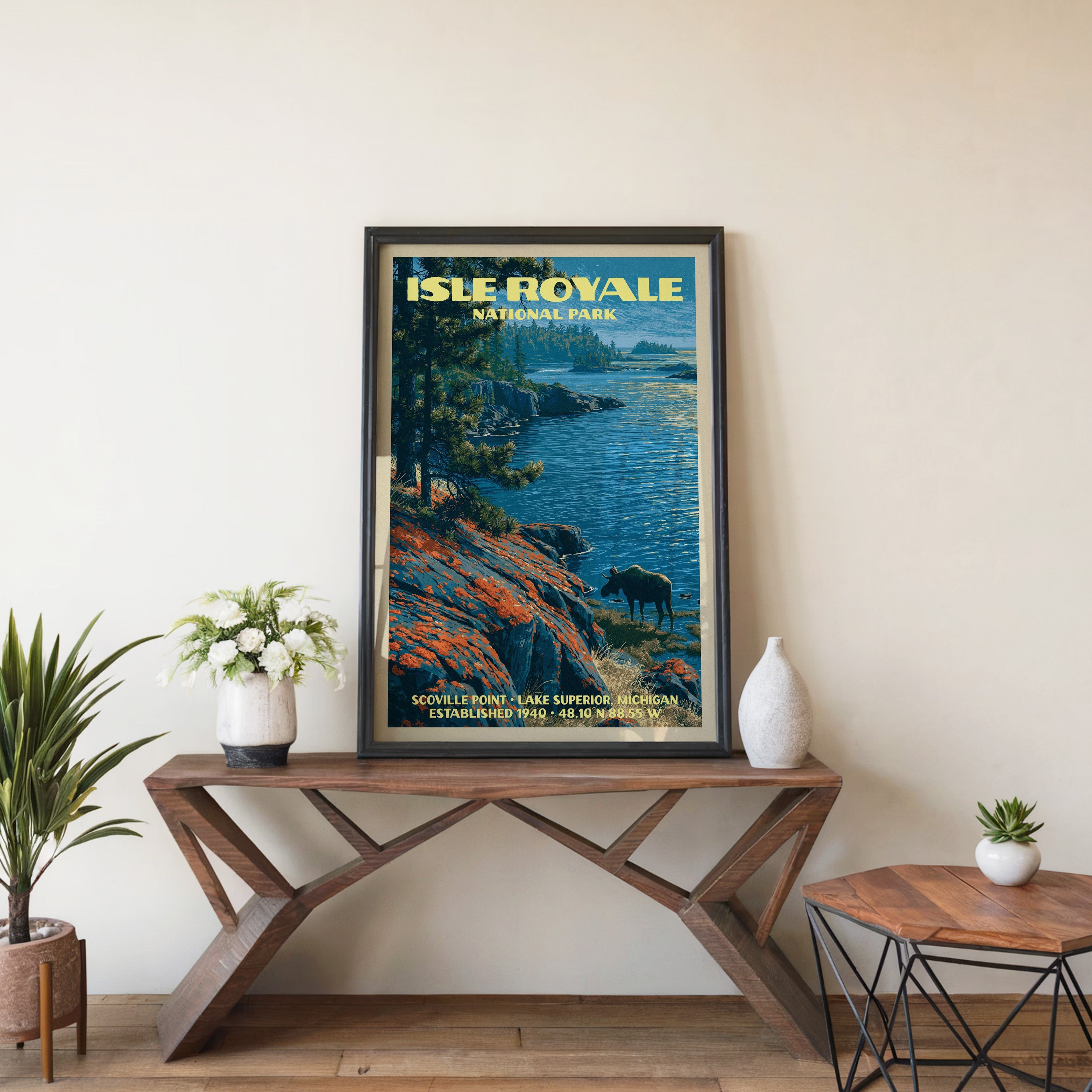 Isle Royale Scoville Point wall art in black, leaning on a walnut console with white anemones and a vase