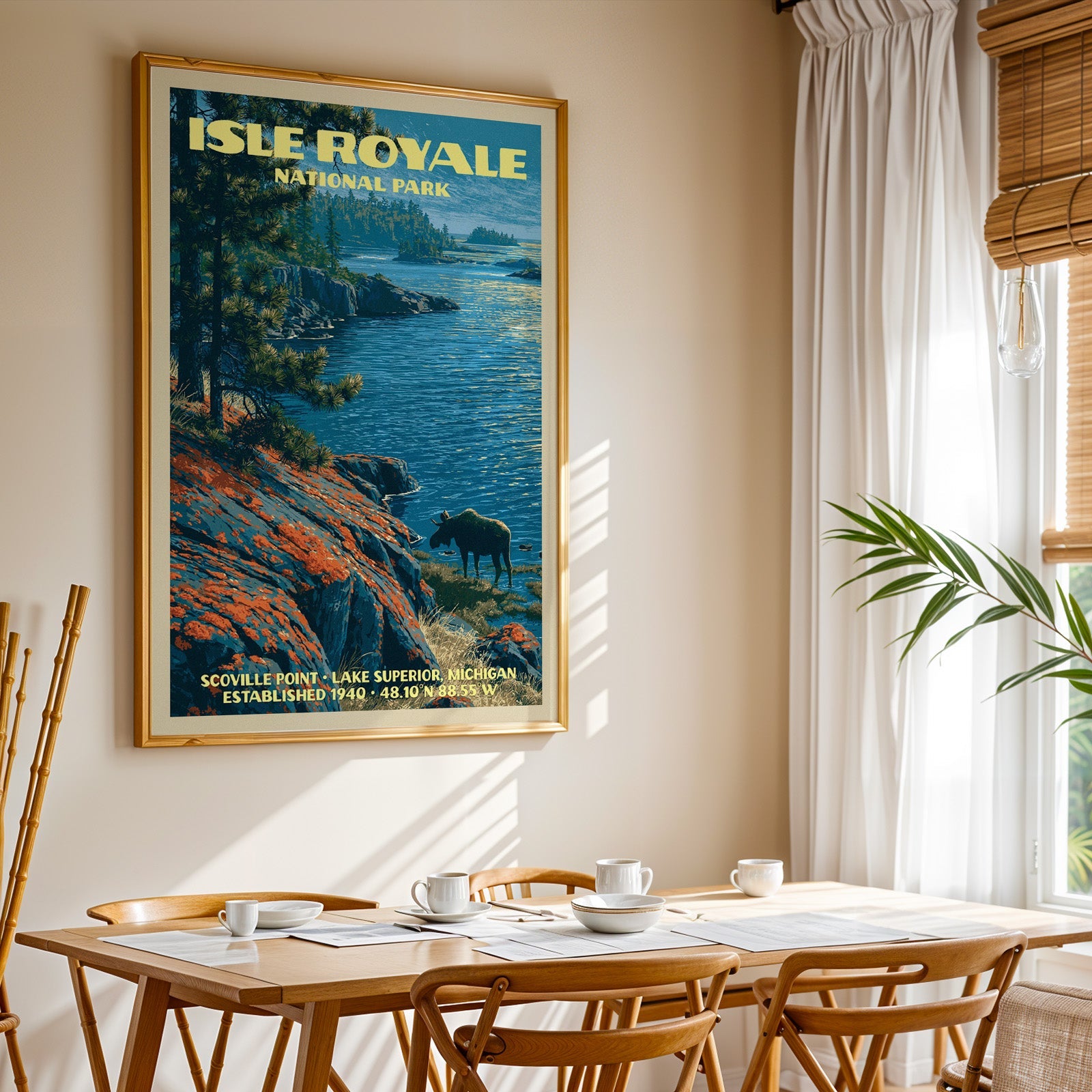 Isle Royale National Park print in gold above a light oak dining table by a curtained window