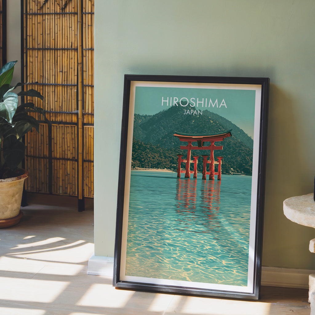Itsukushima Shrine Miyajima Japan wall art in a black frame leaning against a sage green wall beside a bamboo screen