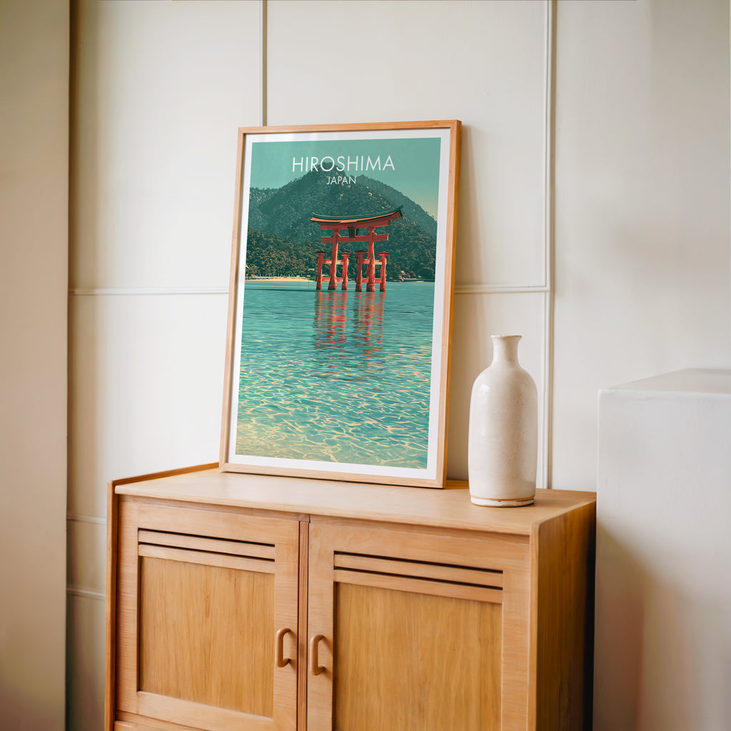 Small Itsukushima Shrine Miyajima Japan travel poster in an oak frame on a mid-century sideboard with a ceramic vase