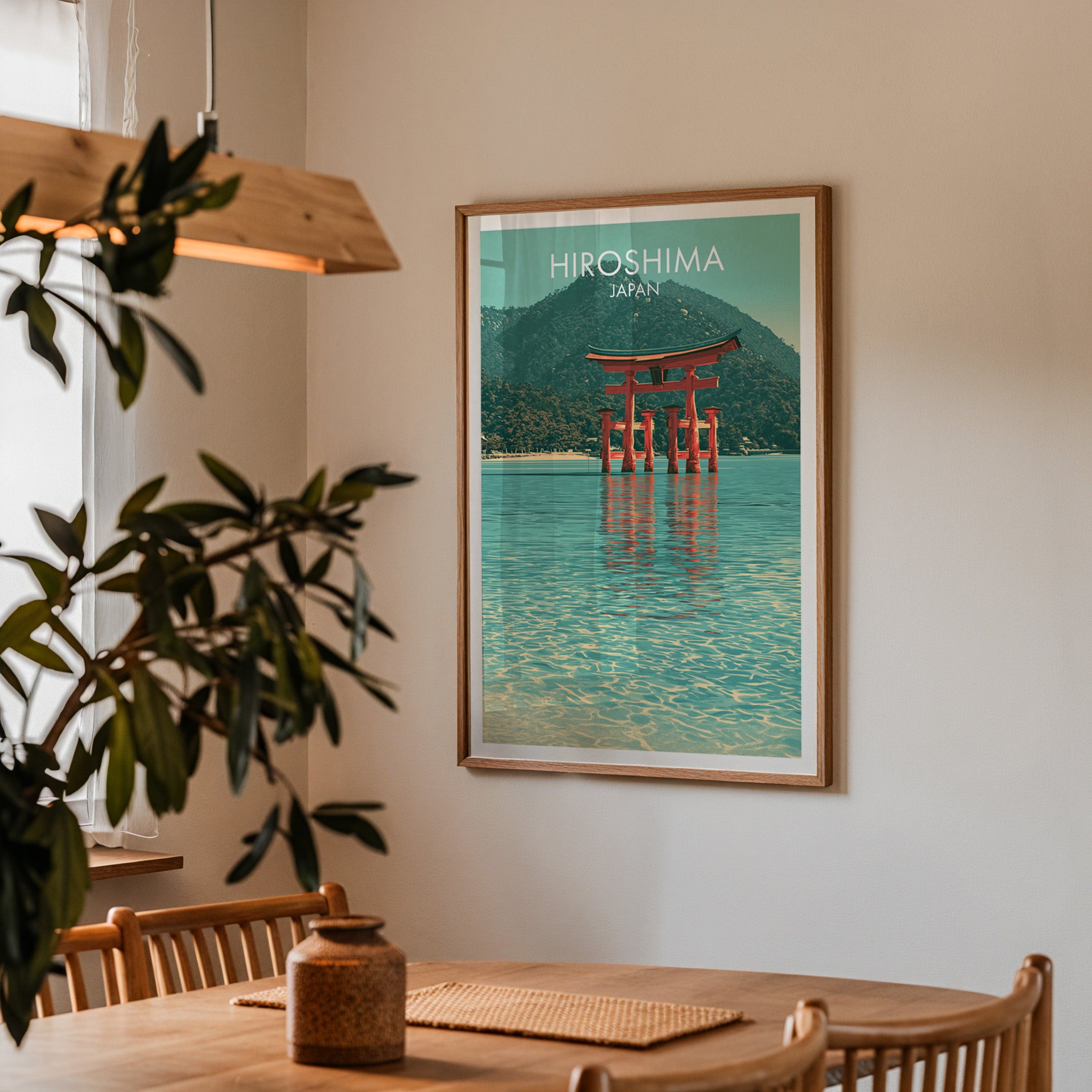 Framed Itsukushima Shrine Miyajima Japan print on a dining room wall above an oak table in warm afternoon light