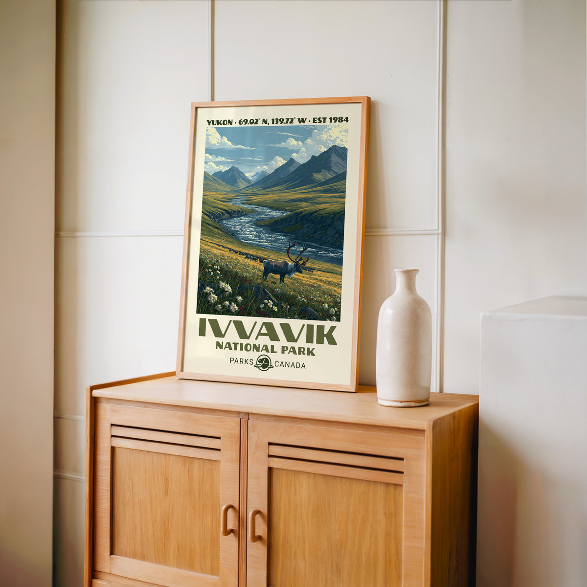 Ivvavik National Park wall art, Yukon in an oak frame on a light wood cabinet beside a stoneware vase