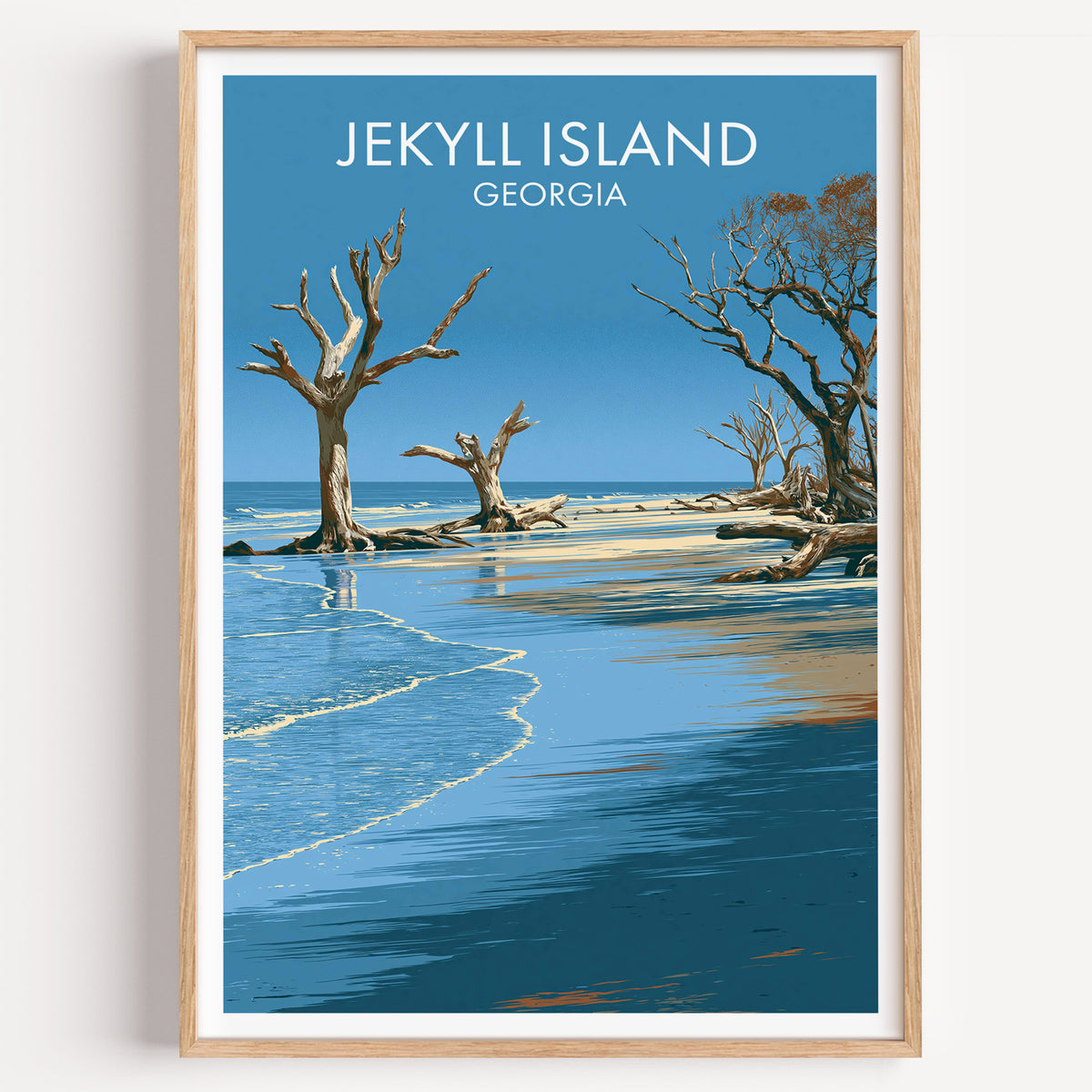 Driftwood Beach Jekyll Island travel poster in an oak frame on a plain white wall, shot straight on