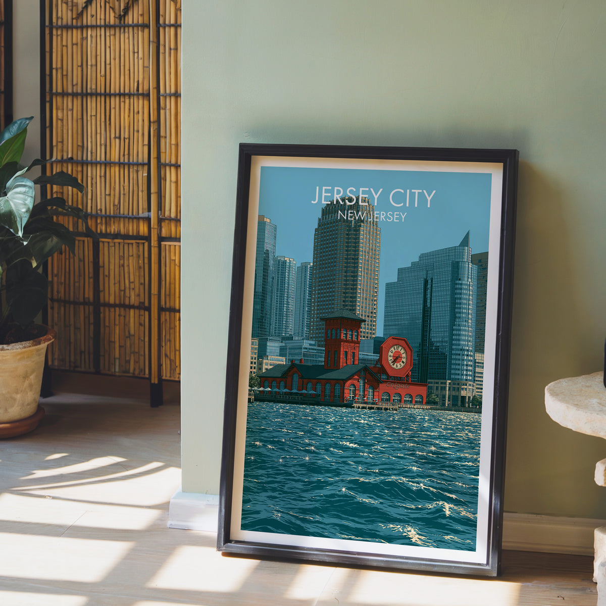 Octagonal harbour clock print in a black frame by a sage wall with bamboo screen and a potted orchid.